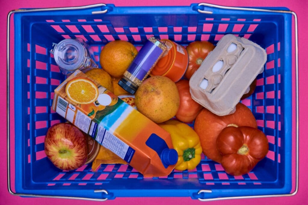 Shopping basket crammed with fruit and juice, like an Instagram post with too much packed into it