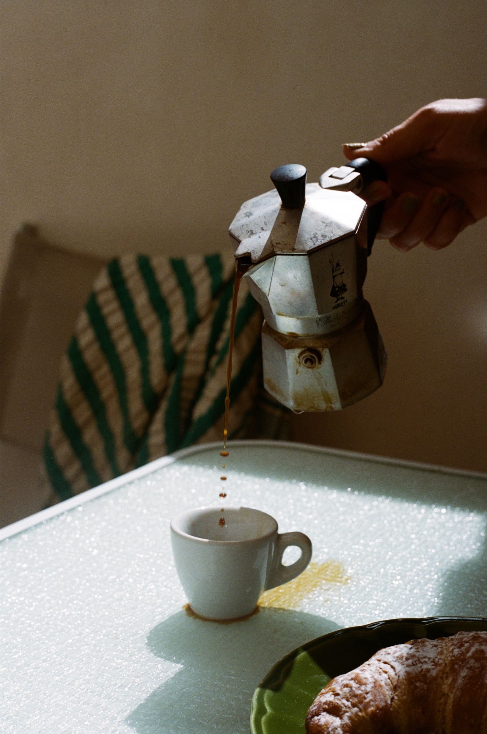 Moka pot pouring coffee into a cup, a simple routine that makes posting consistently on Instagram easier