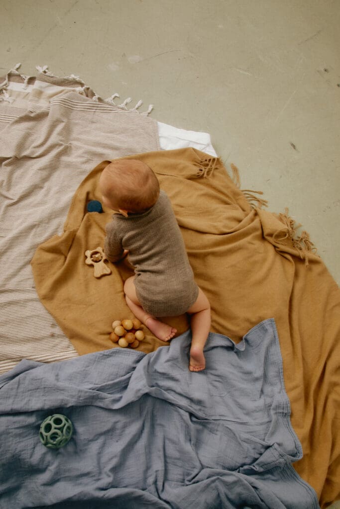 Toddler playing on a blanket, the real life that shapes how much time you can spend on social media