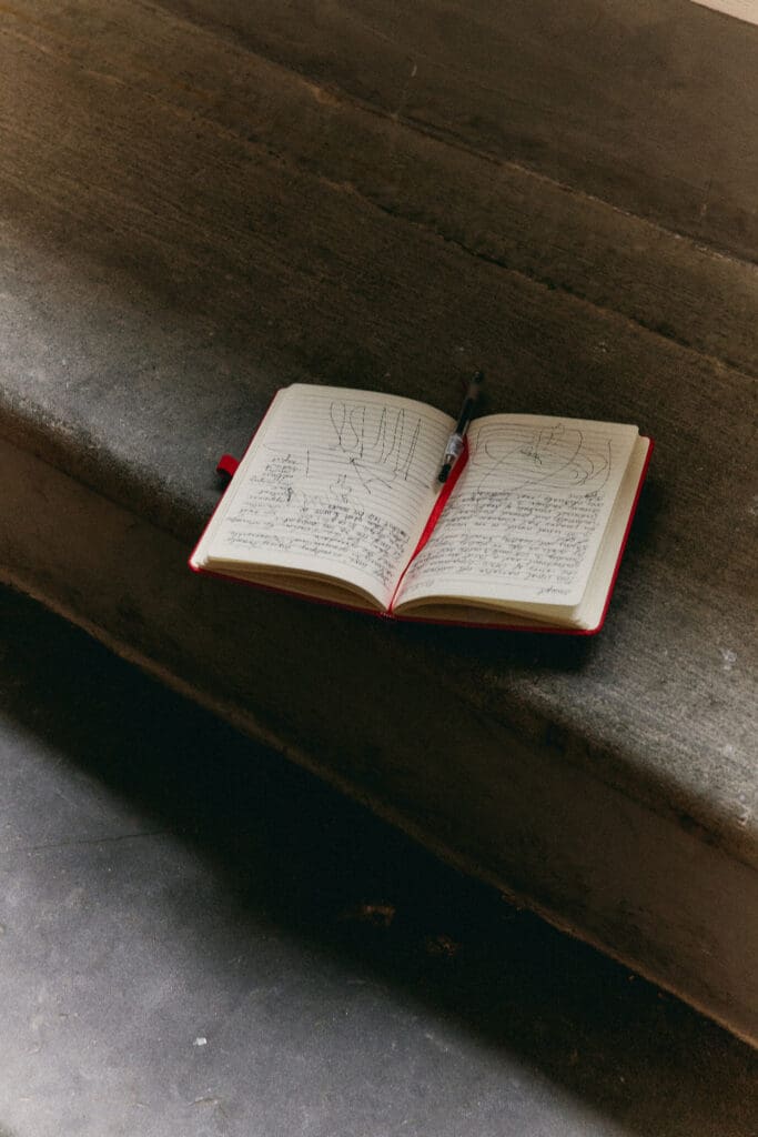 Open notebook on a sofa, a simple Instagram content plan in progress